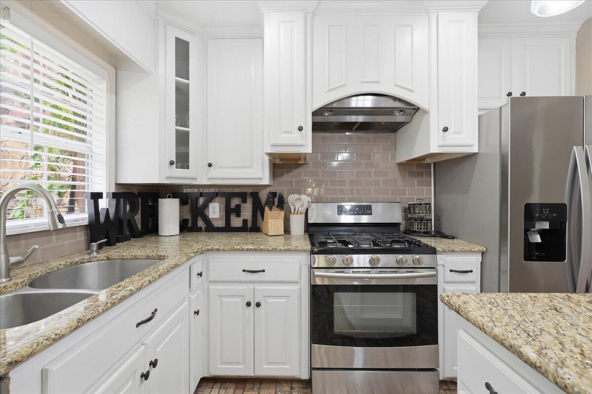 2702 20th Street Lubbock, TX 79410 - Photo 8 of 34 a kitchen with granite countertop a stove sink and refrigerator
