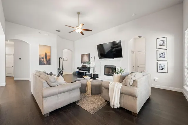 a living room with furniture a fireplace and a flat screen tv