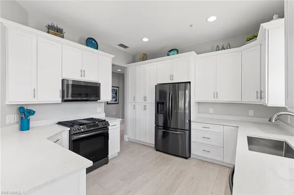 a kitchen with stainless steel appliances a refrigerator stove microwave and sink