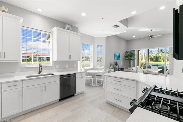 a kitchen with a sink stove and cabinets