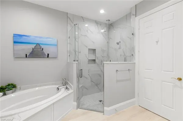 a bathroom with a bathtub and a shower