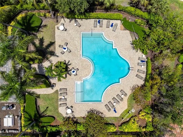 a view of a swimming pool with lounge chairs