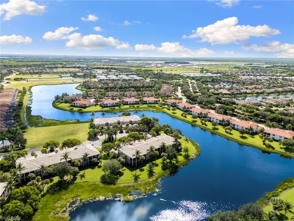 an aerial view of residential houses with outdoor space and swimming pool