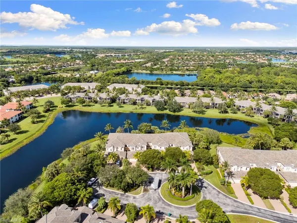 an aerial view of residential houses with outdoor space and river