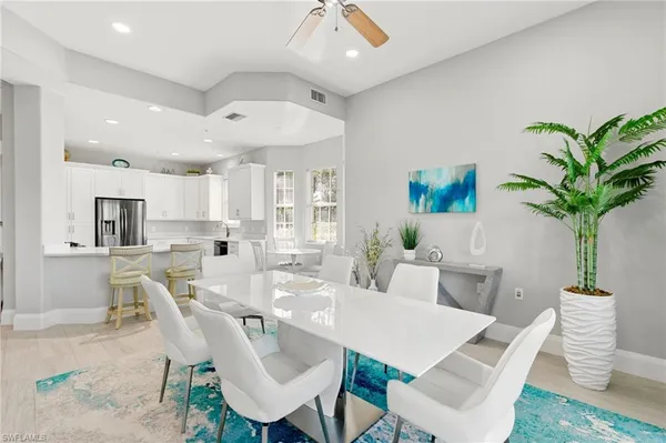 a view of a dining room with furniture wooden floor and chandelier