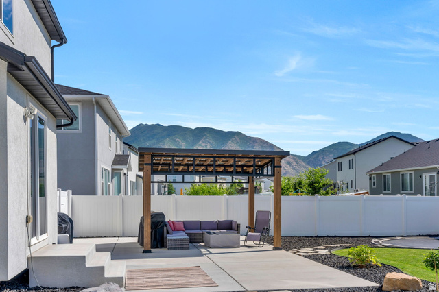 252 North Sunrise Rnch Drive Mapleton, UT 84664 - Photo 51 of 62 Outdoor patio featuring a modern pergola with a slatted roof, concrete patio, and a privacy fence