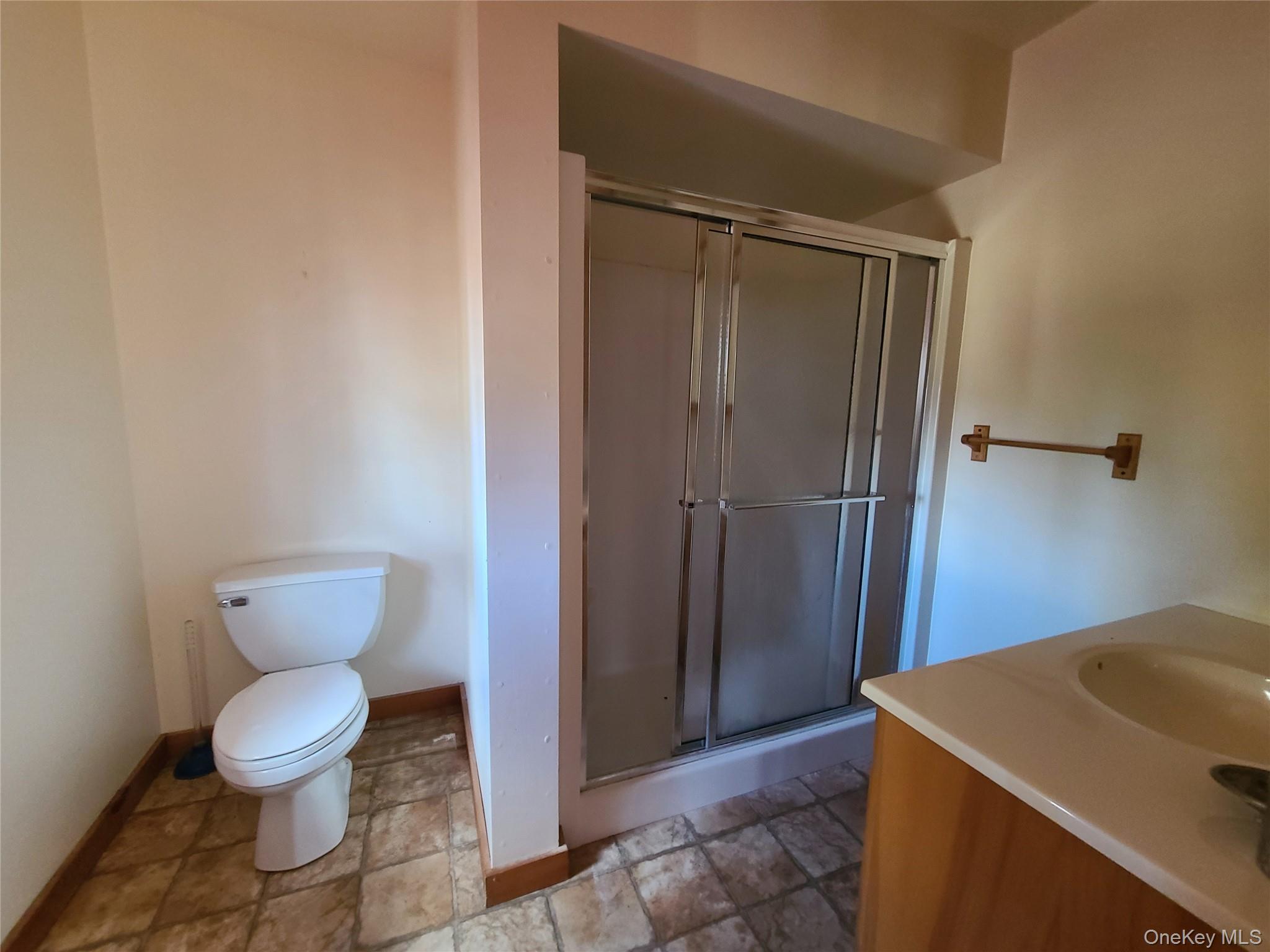 118 Hilltop Road Monticello, NY 12701 - Photo 20 of 45 Full bath featuring vanity, a stall shower, and stone finish flooring