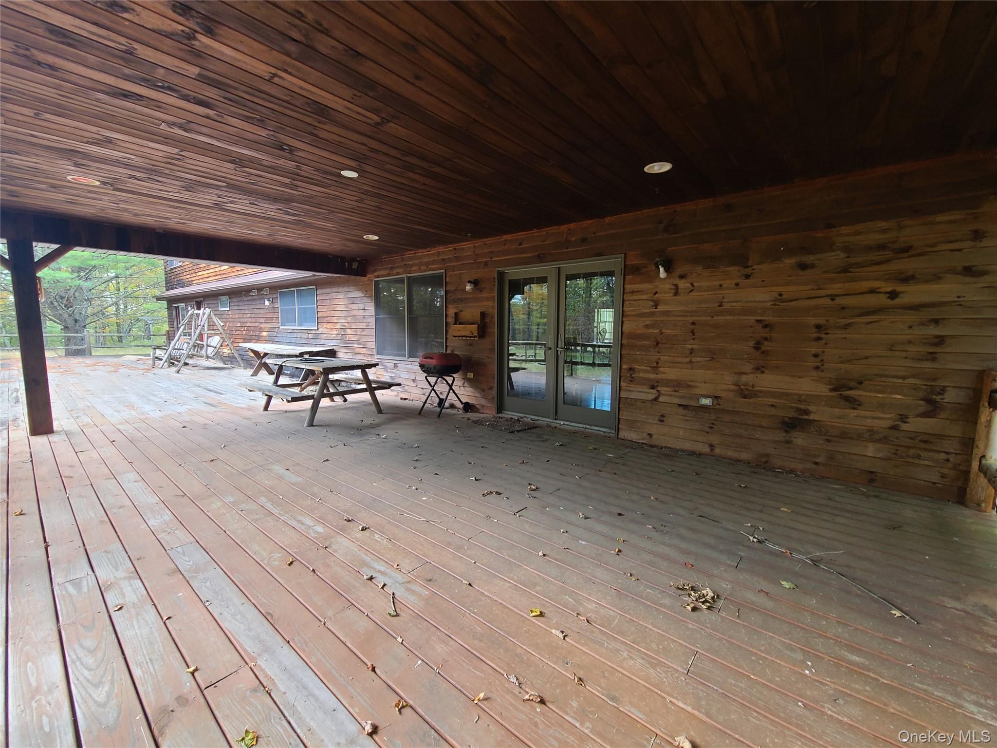 118 Hilltop Road Monticello, NY 12701 - Photo 24 of 45 a view of a patio with table and chairs with wooden floor