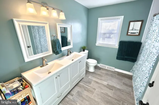 a bathroom with a sink toilet and mirror