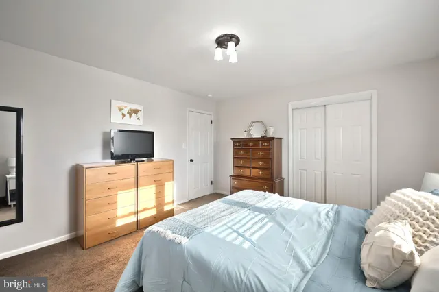 a bedroom with a bed and a television