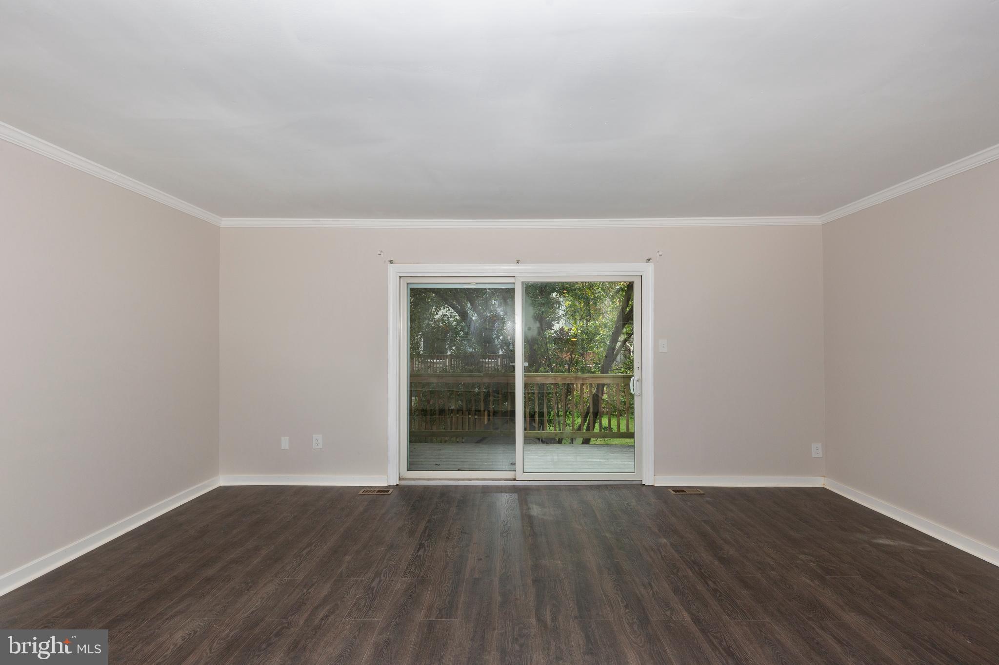 7459 Setting Sun Way Columbia, MD 21046 - Photo 11 of 33 an empty room with wooden floor and windows