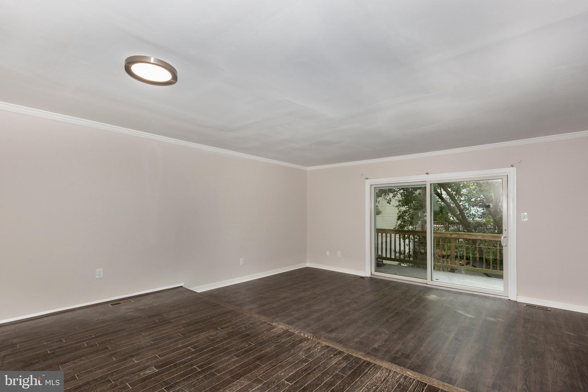 7459 Setting Sun Way Columbia, MD 21046 - Photo 12 of 33 an empty room with wooden floor and windows