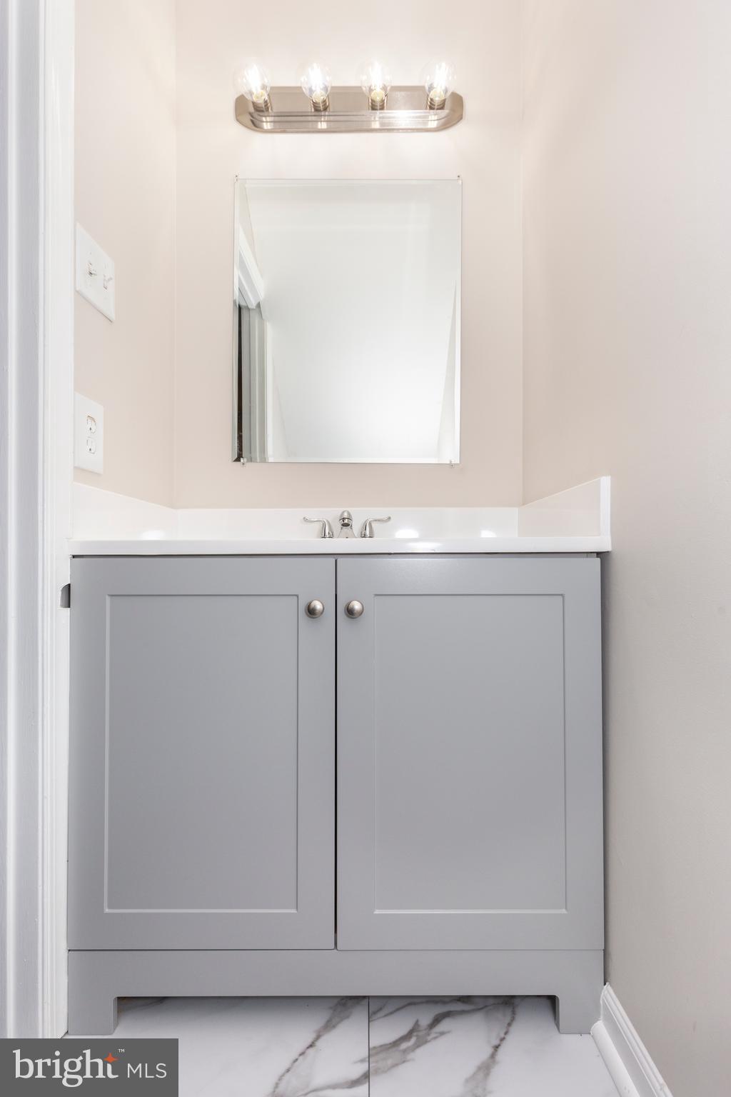 7459 Setting Sun Way Columbia, MD 21046 - Photo 13 of 33 a bathroom with a sink a mirror and vanity