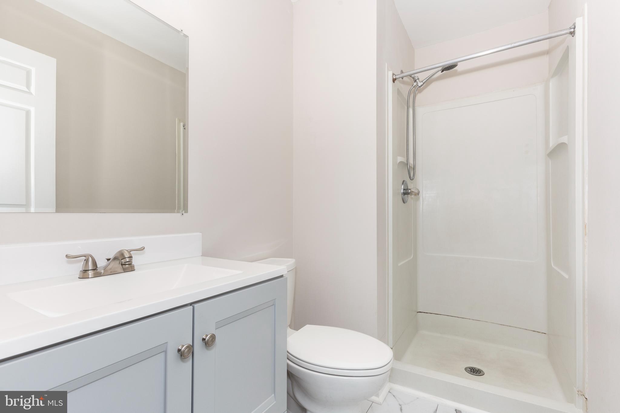 7459 Setting Sun Way Columbia, MD 21046 - Photo 14 of 33 a bathroom with a sink a toilet and shower