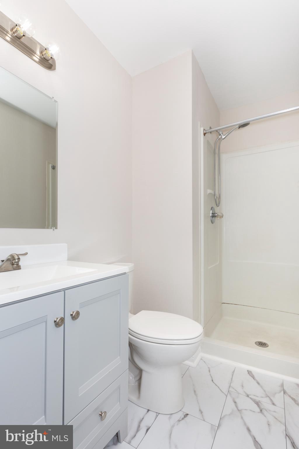 7459 Setting Sun Way Columbia, MD 21046 - Photo 15 of 33 a bathroom with a sink a toilet and shower