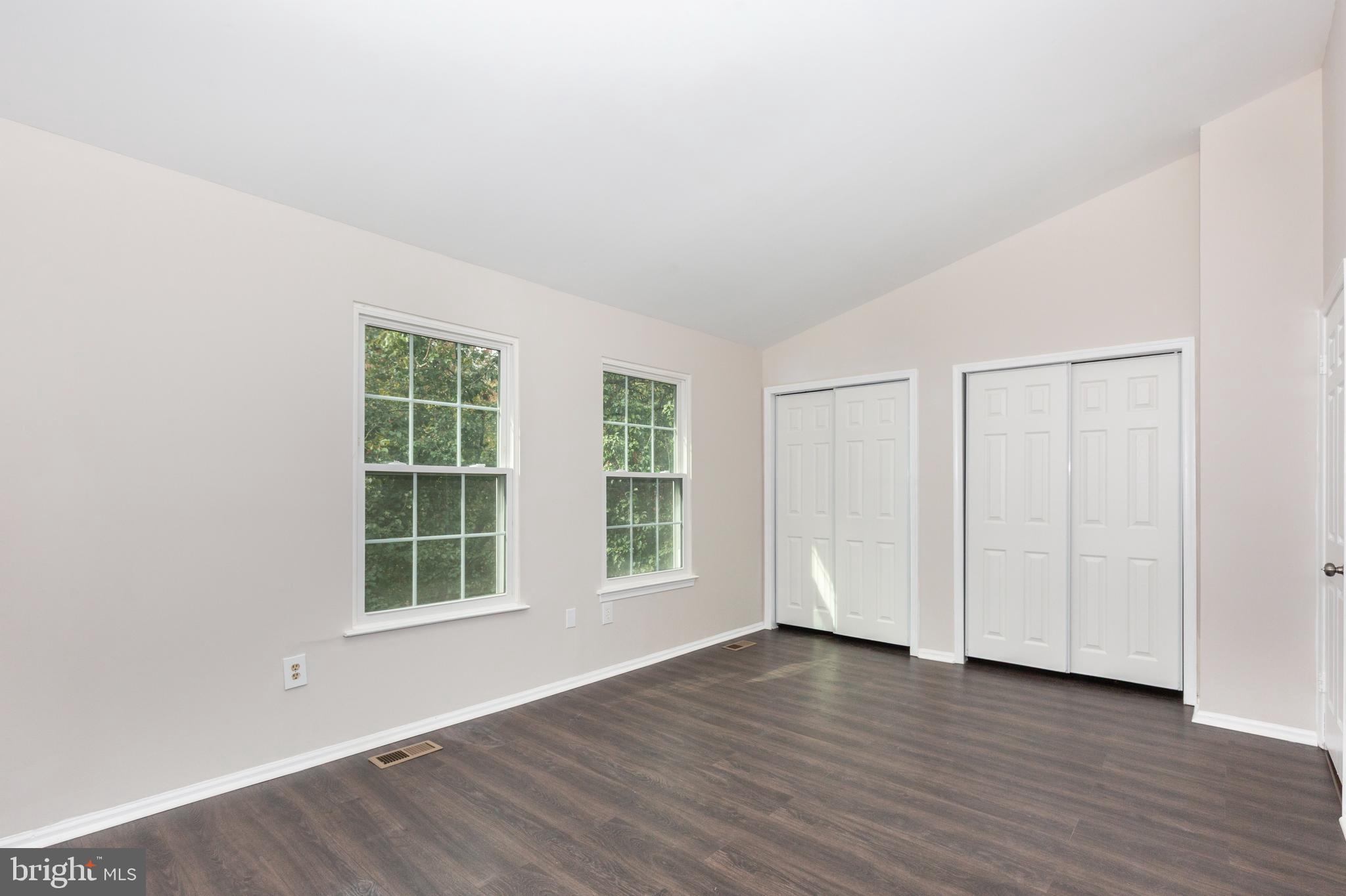 7459 Setting Sun Way Columbia, MD 21046 - Photo 16 of 33 an empty room with wooden floor and windows