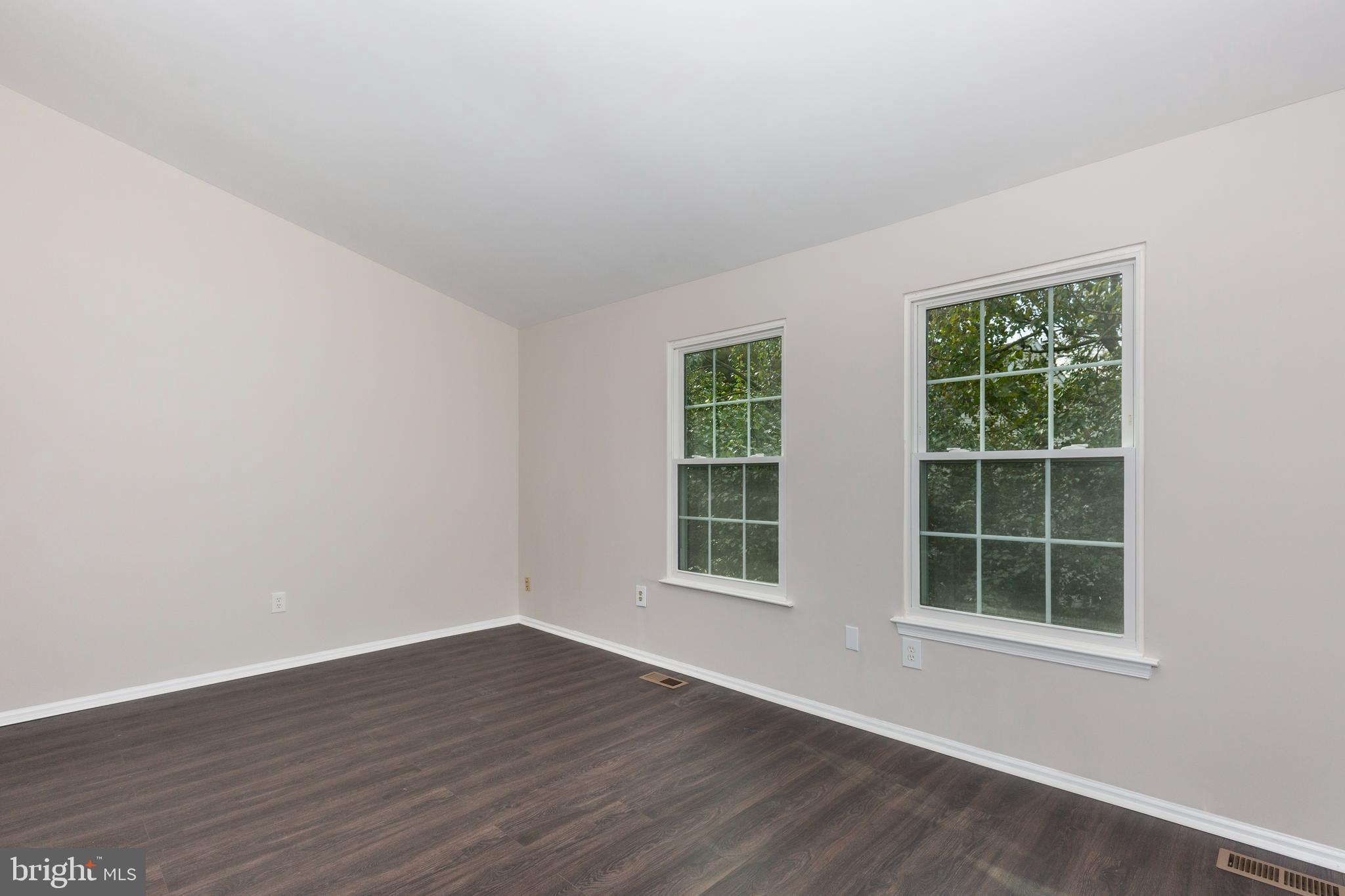 7459 Setting Sun Way Columbia, MD 21046 - Photo 17 of 33 an empty room with wooden floor and windows