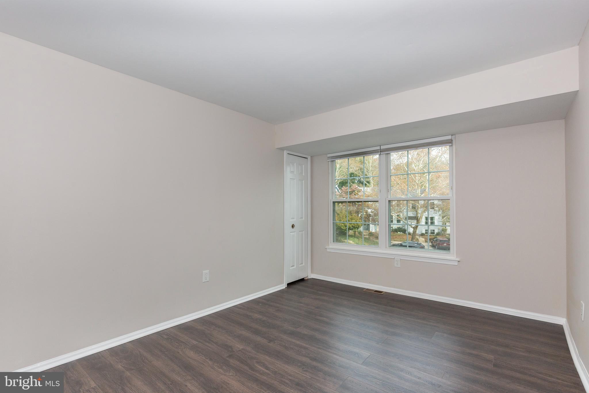 7459 Setting Sun Way Columbia, MD 21046 - Photo 18 of 33 an empty room with wooden floor and windows