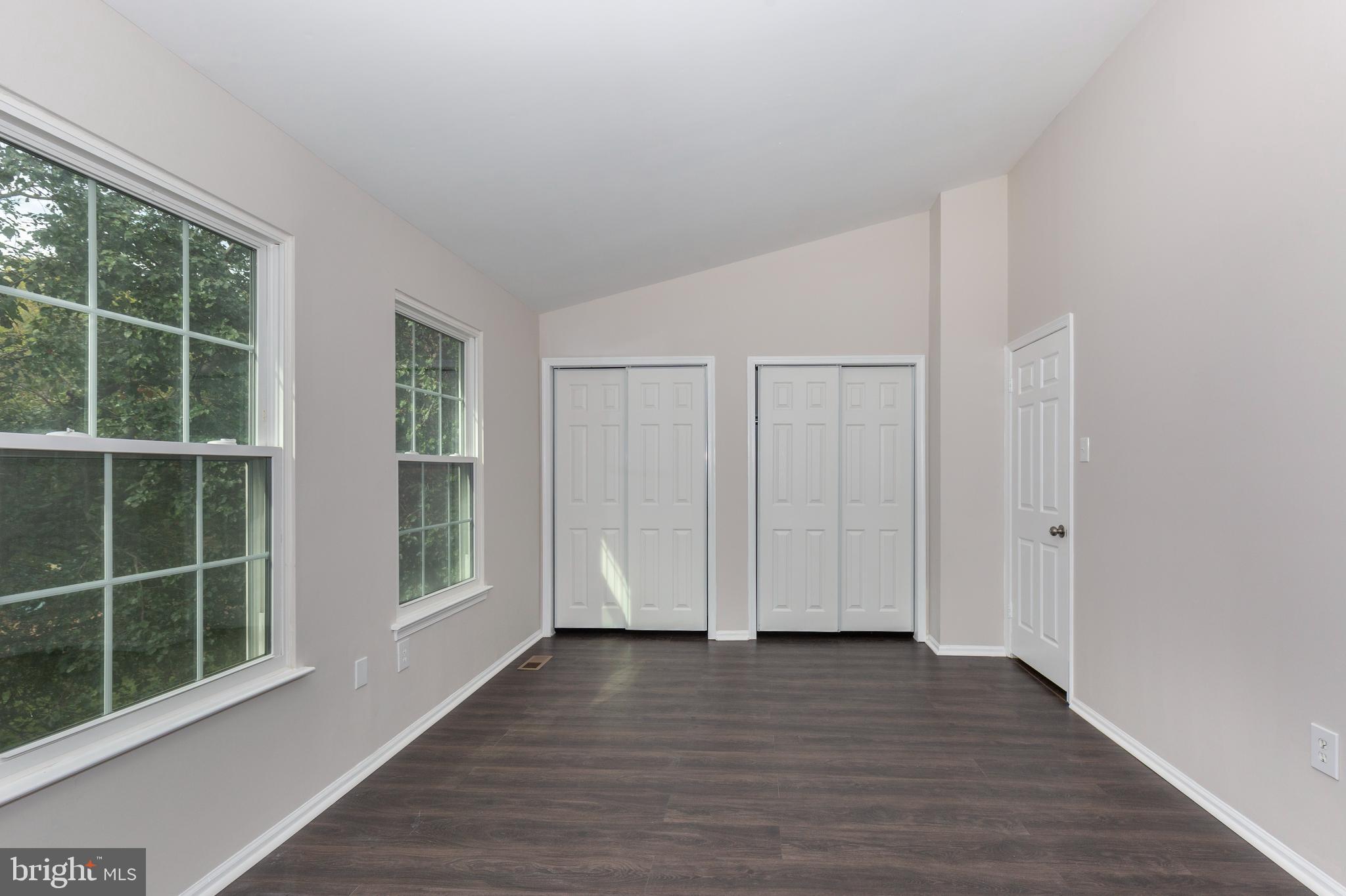 7459 Setting Sun Way Columbia, MD 21046 - Photo 19 of 33 a view of empty room with wooden floor and fan