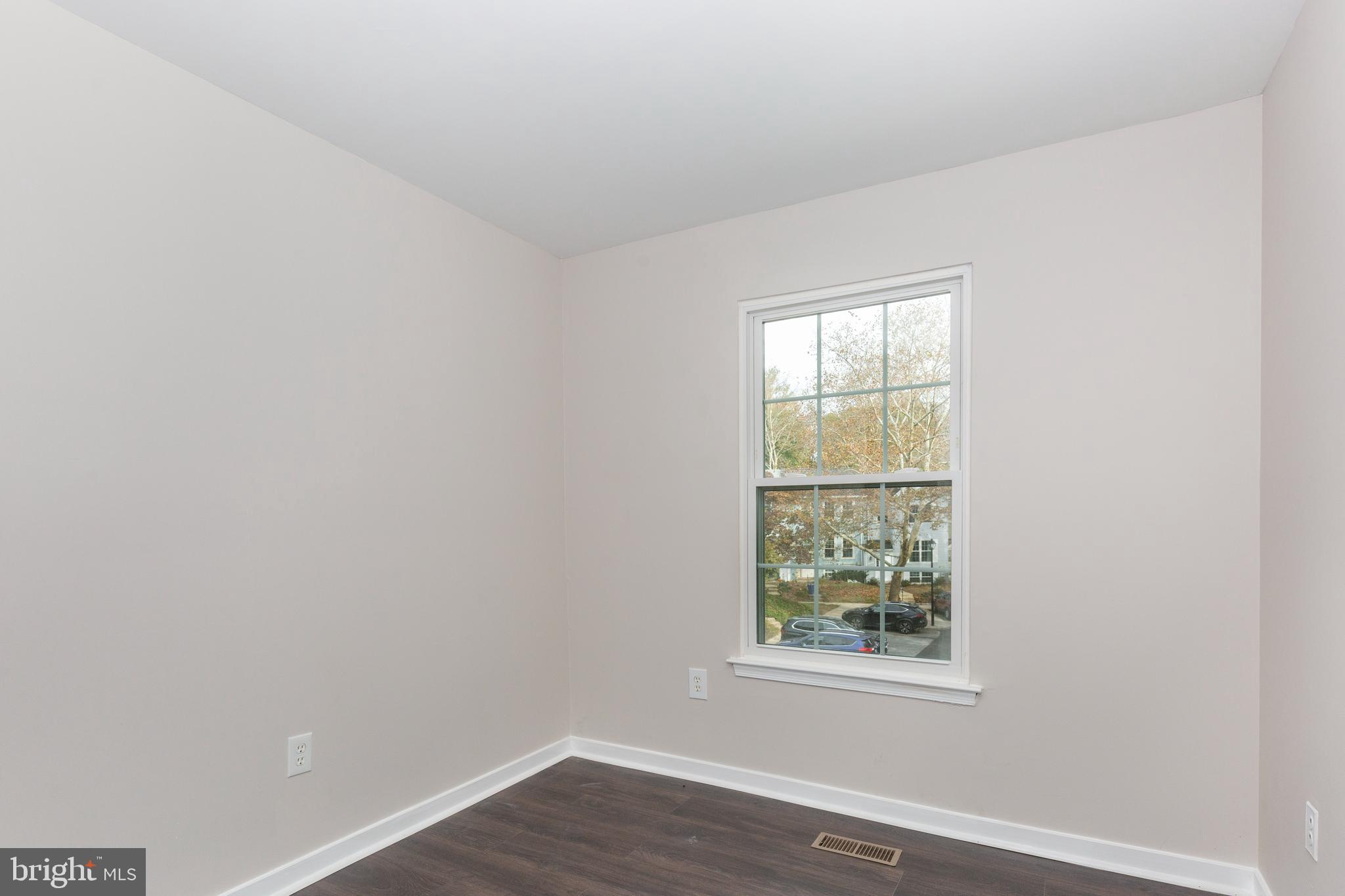 7459 Setting Sun Way Columbia, MD 21046 - Photo 24 of 33 an empty room with wooden floor and windows