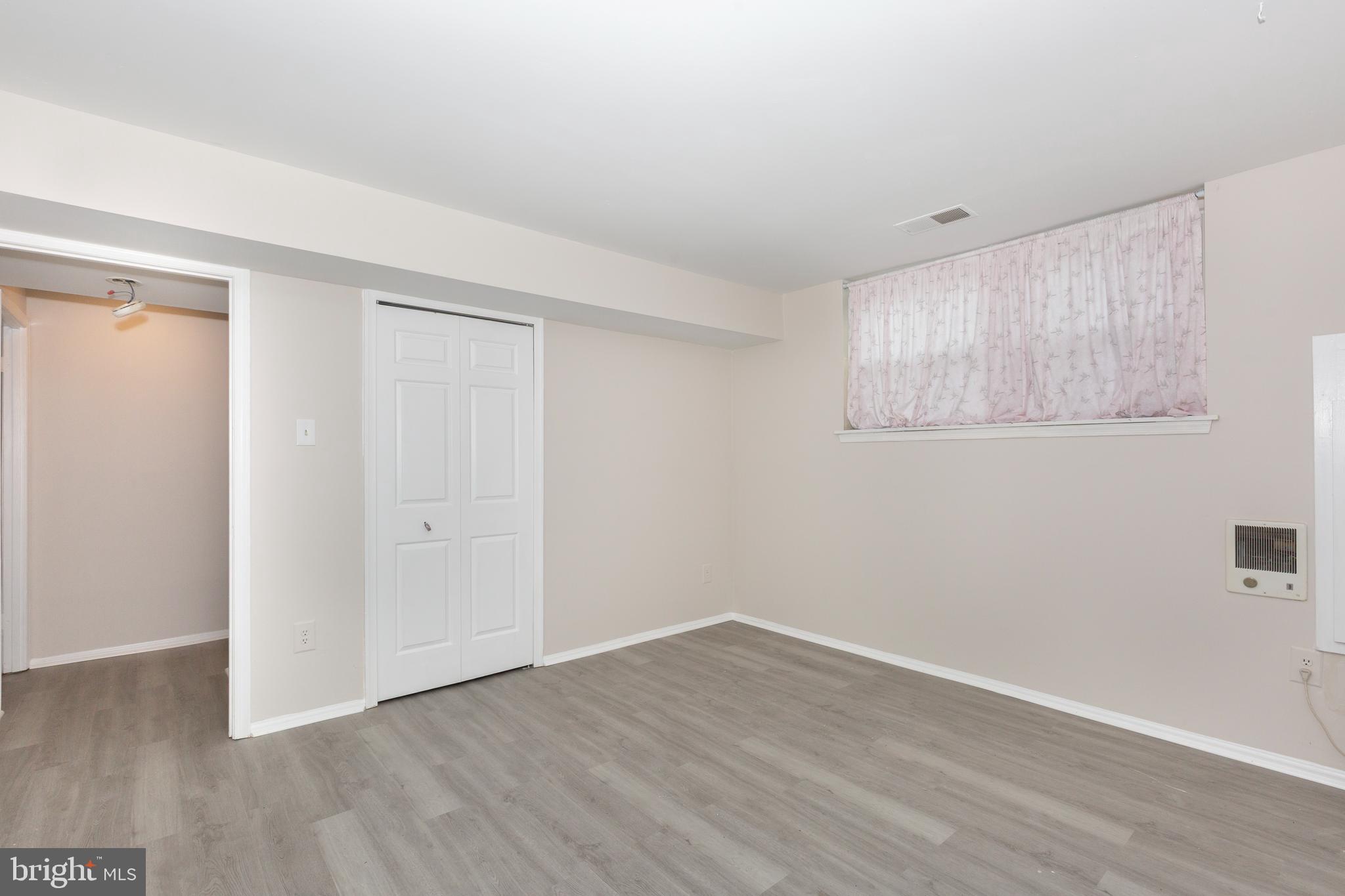 7459 Setting Sun Way Columbia, MD 21046 - Photo 27 of 33 a view of an empty room with wooden floor and a window