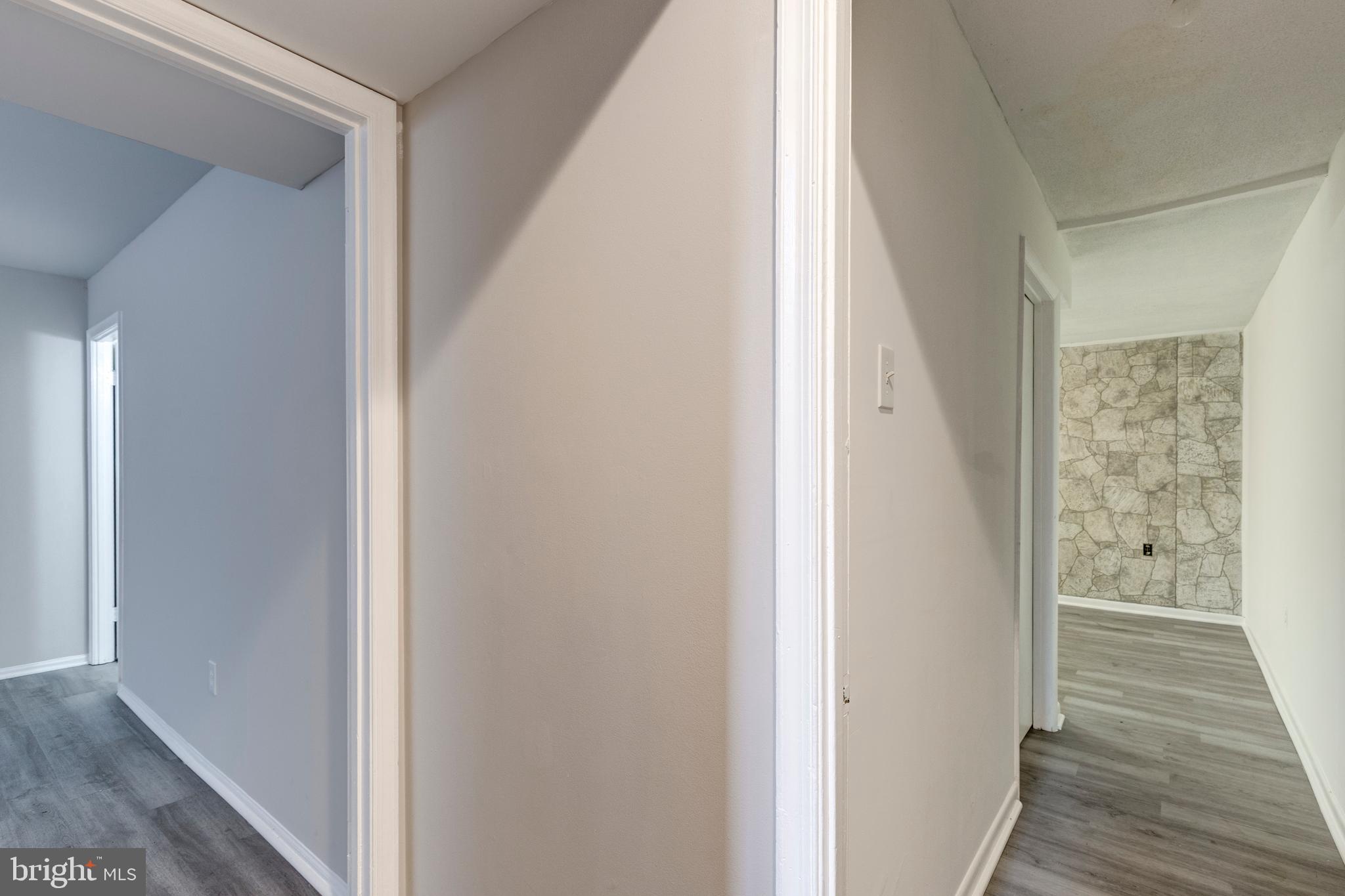 7459 Setting Sun Way Columbia, MD 21046 - Photo 29 of 33 a view of a hallway with wooden floor and staircase