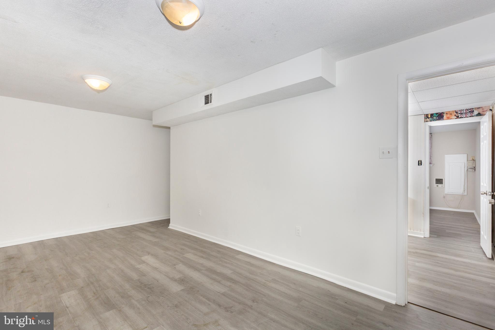 7459 Setting Sun Way Columbia, MD 21046 - Photo 31 of 33 a view of an empty room with wooden floor and a window