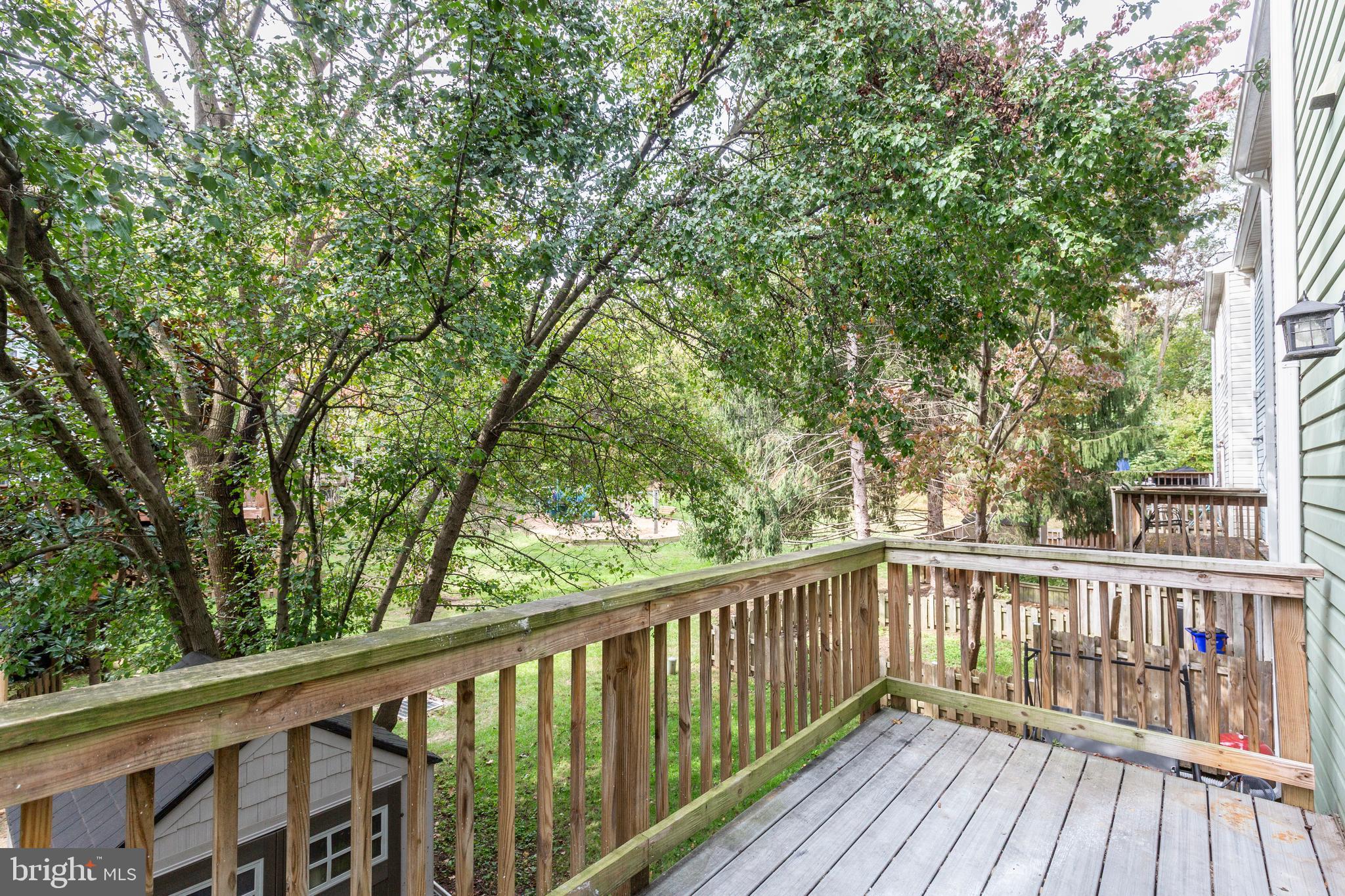 7459 Setting Sun Way Columbia, MD 21046 - Photo 32 of 33 a view of balcony with wooden floor and fence