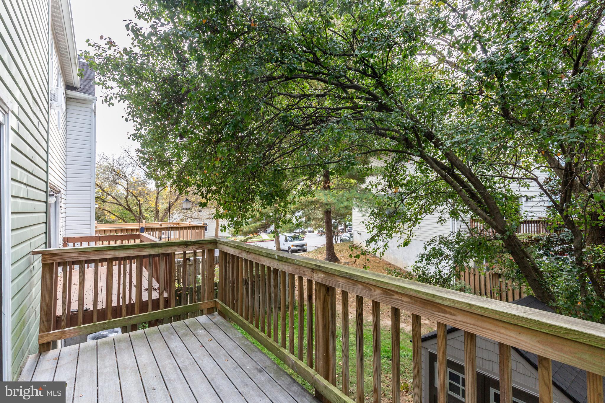 7459 Setting Sun Way Columbia, MD 21046 - Photo 33 of 33 a view of balcony with wooden floor and fence