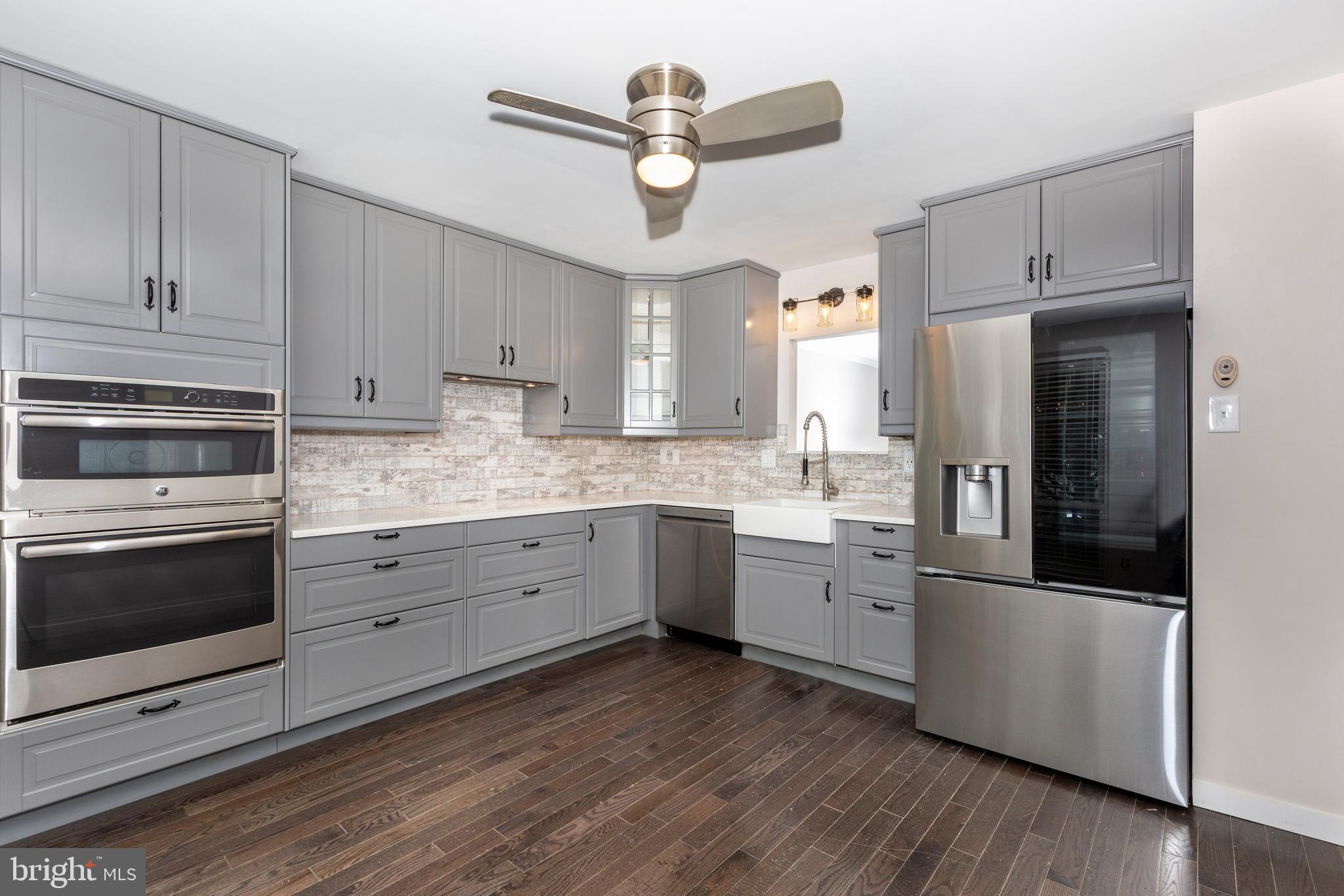 7459 Setting Sun Way Columbia, MD 21046 - Photo 6 of 33 a kitchen with granite countertop cabinets stainless steel appliances and a chandelier