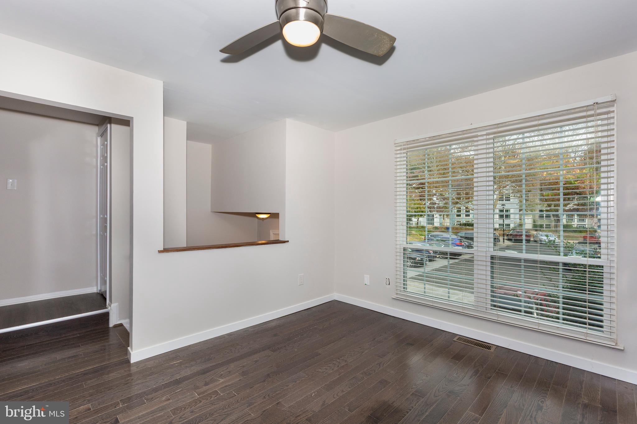 7459 Setting Sun Way Columbia, MD 21046 - Photo 7 of 33 a view of livingroom with furniture wooden floor and window