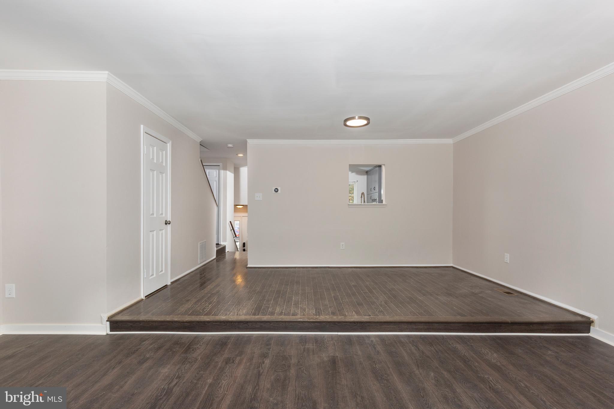 7459 Setting Sun Way Columbia, MD 21046 - Photo 10 of 33 an empty room with wooden floor