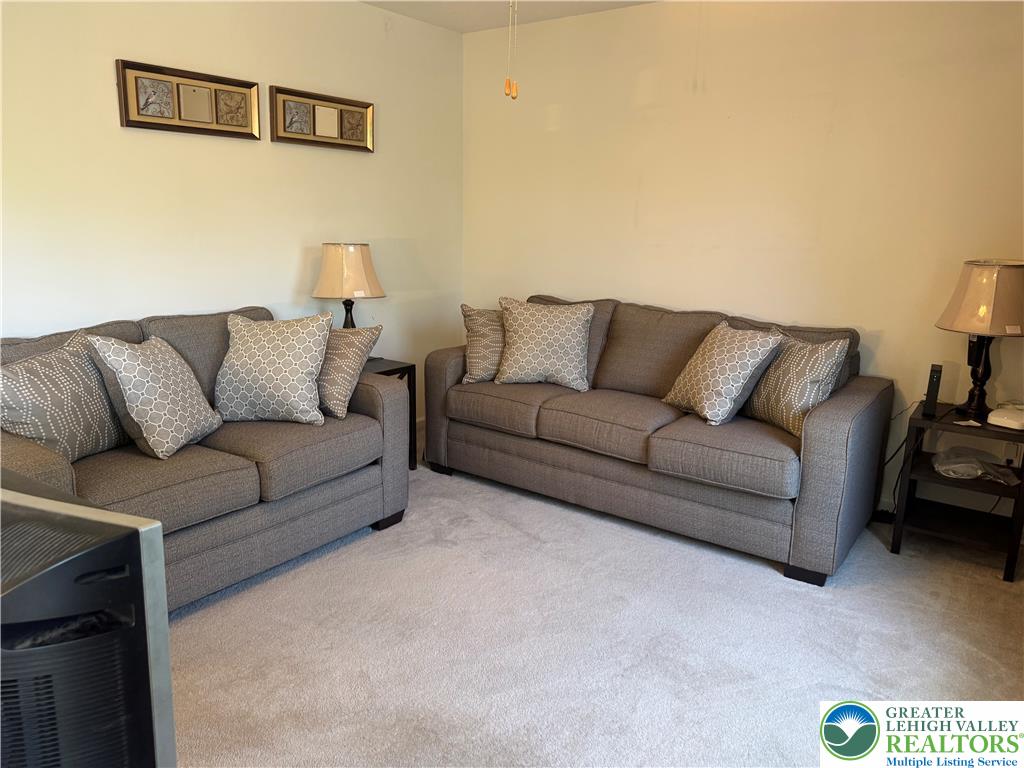 2742 Long Pond Road Long Pond, PA 18334 - Photo 31 of 57 A well-lit sitting room featuring two comfortable sofas and soft carpeting.