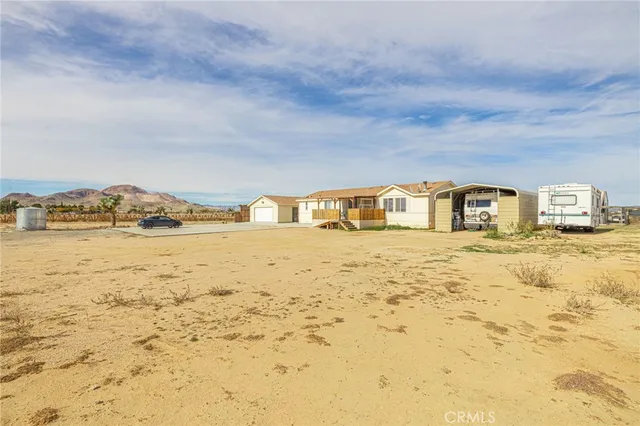a view of a room with gym equipment and wooden floor
