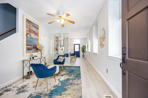 a living room with dining room and couches