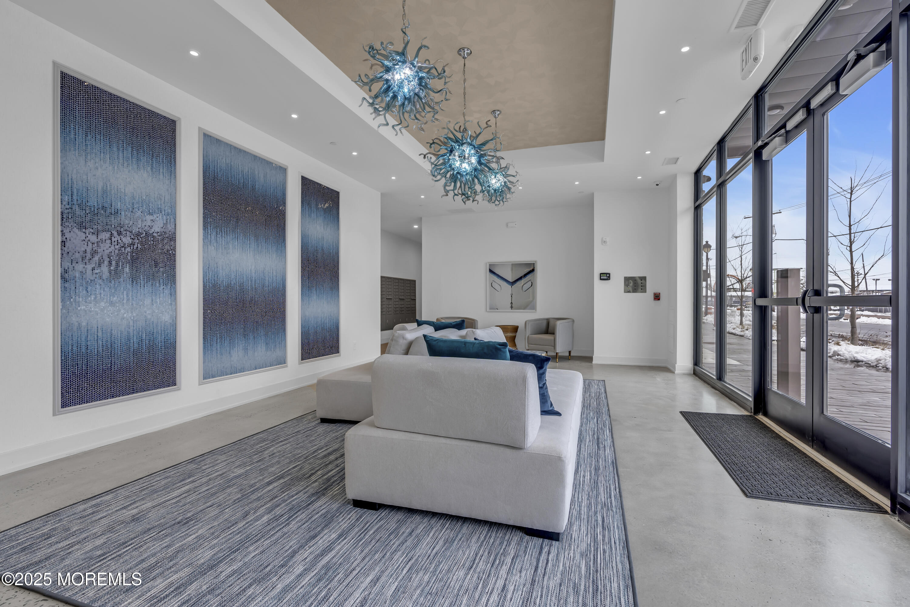 19 Carr Avenue, Unit 414 Keansburg, NJ 07734 - Photo 28 of 83 a living room with furniture and a chandelier