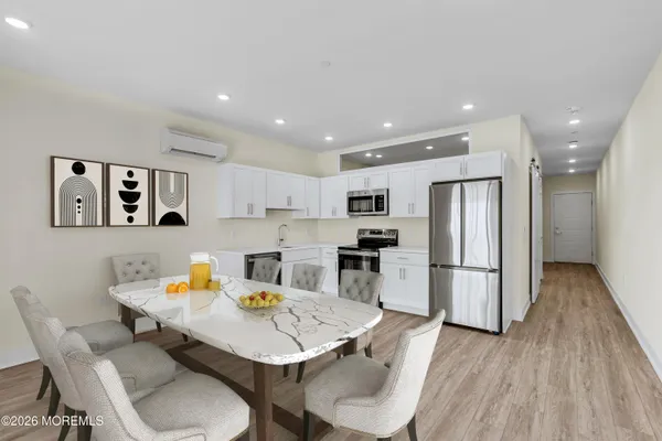 a kitchen with white cabinets and stainless steel appliances