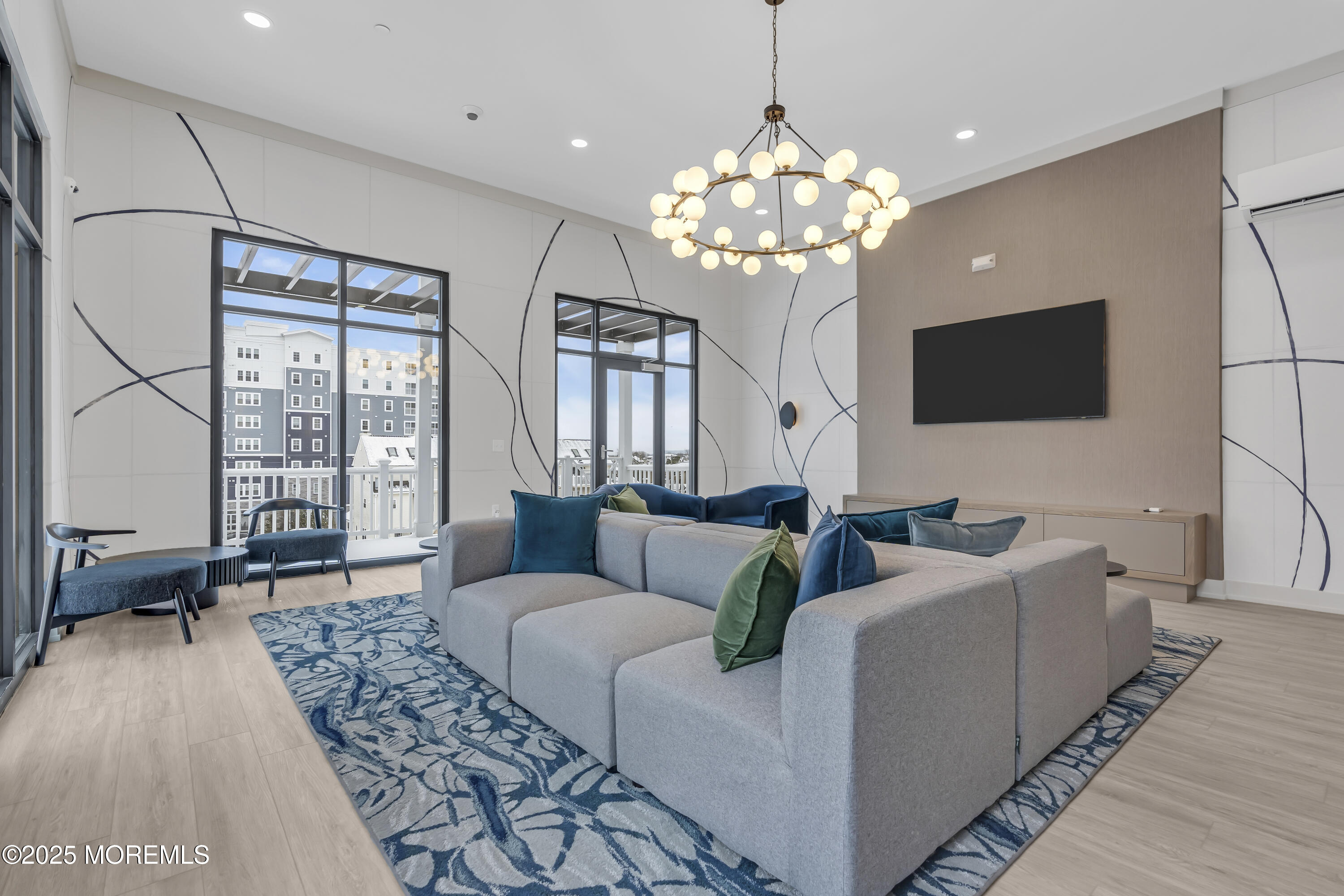 19 Carr Avenue, Unit 414 Keansburg, NJ 07734 - Photo 41 of 83 a living room with furniture a chandelier and a flat screen tv