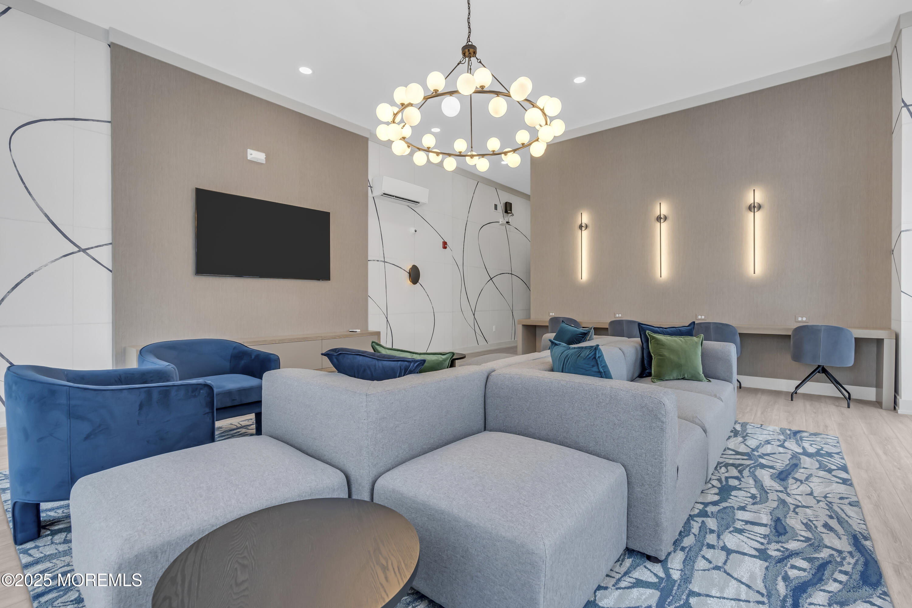 19 Carr Avenue, Unit 414 Keansburg, NJ 07734 - Photo 48 of 83 a living room with furniture a chandelier and a flat screen tv