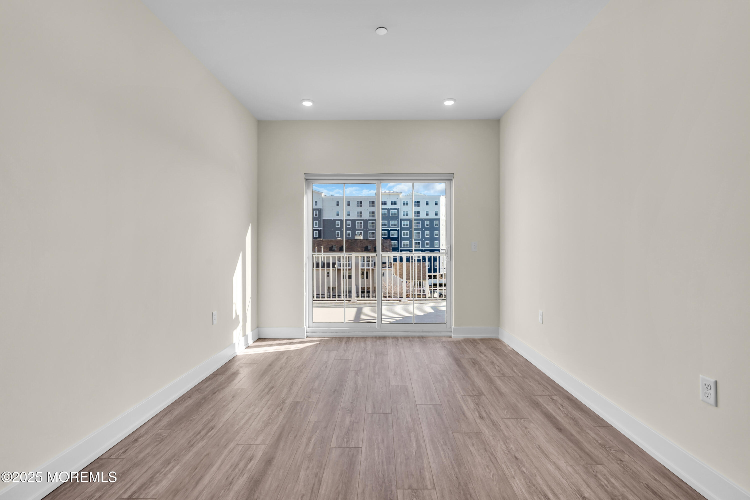 19 Carr Avenue, Unit 414 Keansburg, NJ 07734 - Photo 58 of 83 an empty room with wooden floor and windows