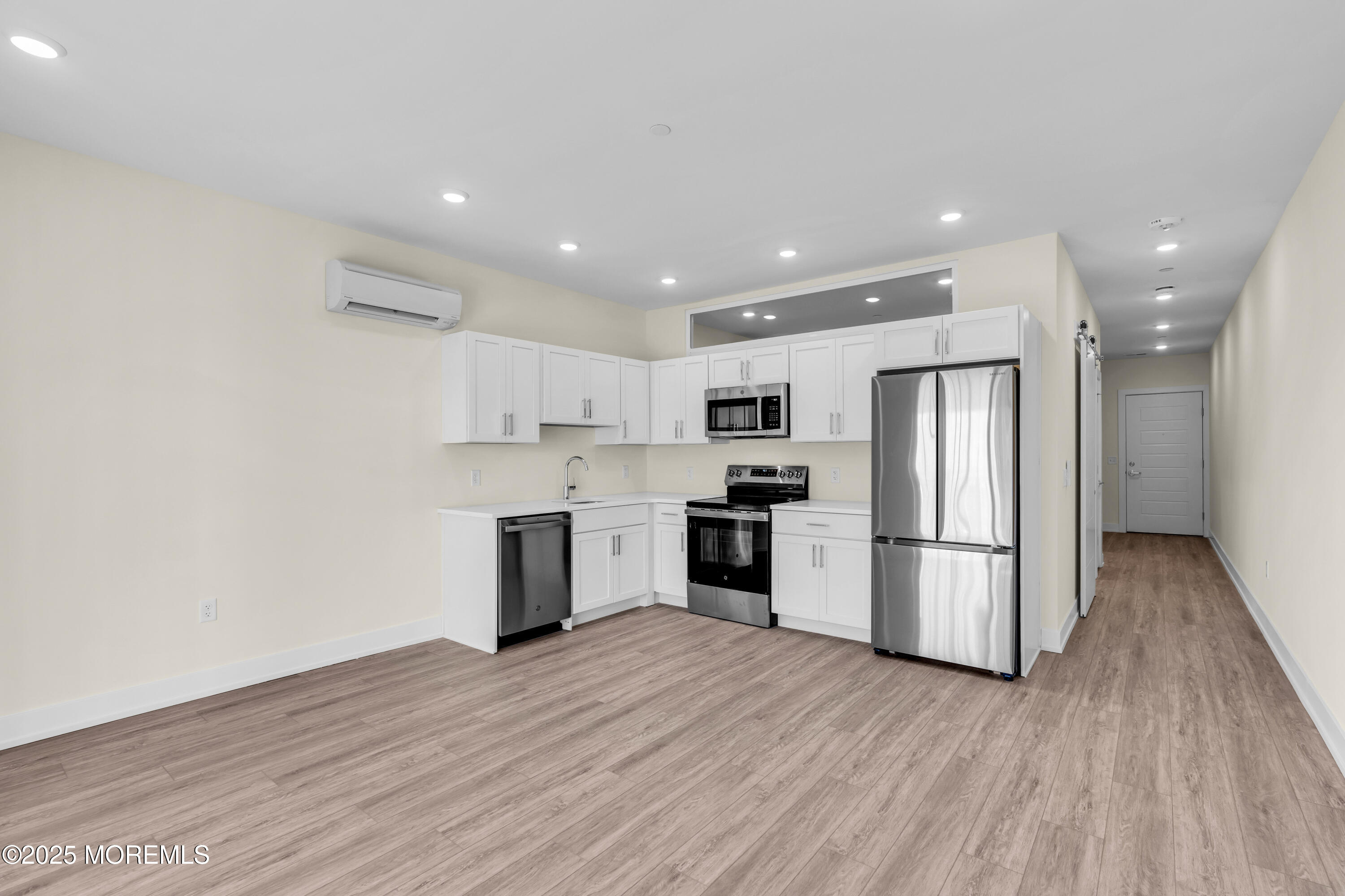 19 Carr Avenue, Unit 414 Keansburg, NJ 07734 - Photo 67 of 83 a kitchen with stainless steel appliances a refrigerator and wooden floor