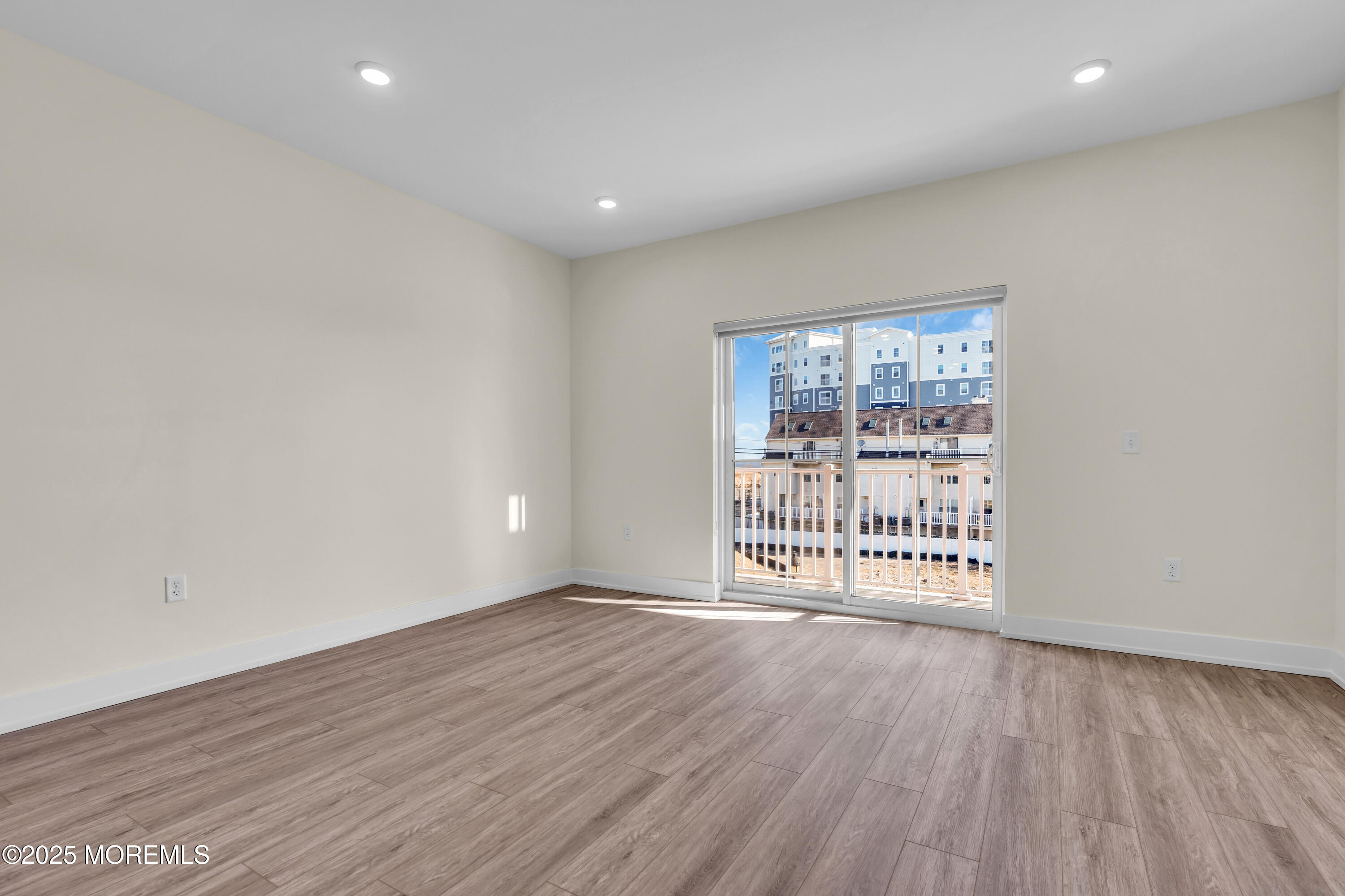 19 Carr Avenue, Unit 414 Keansburg, NJ 07734 - Photo 70 of 83 a view of an empty room with wooden floor and a window
