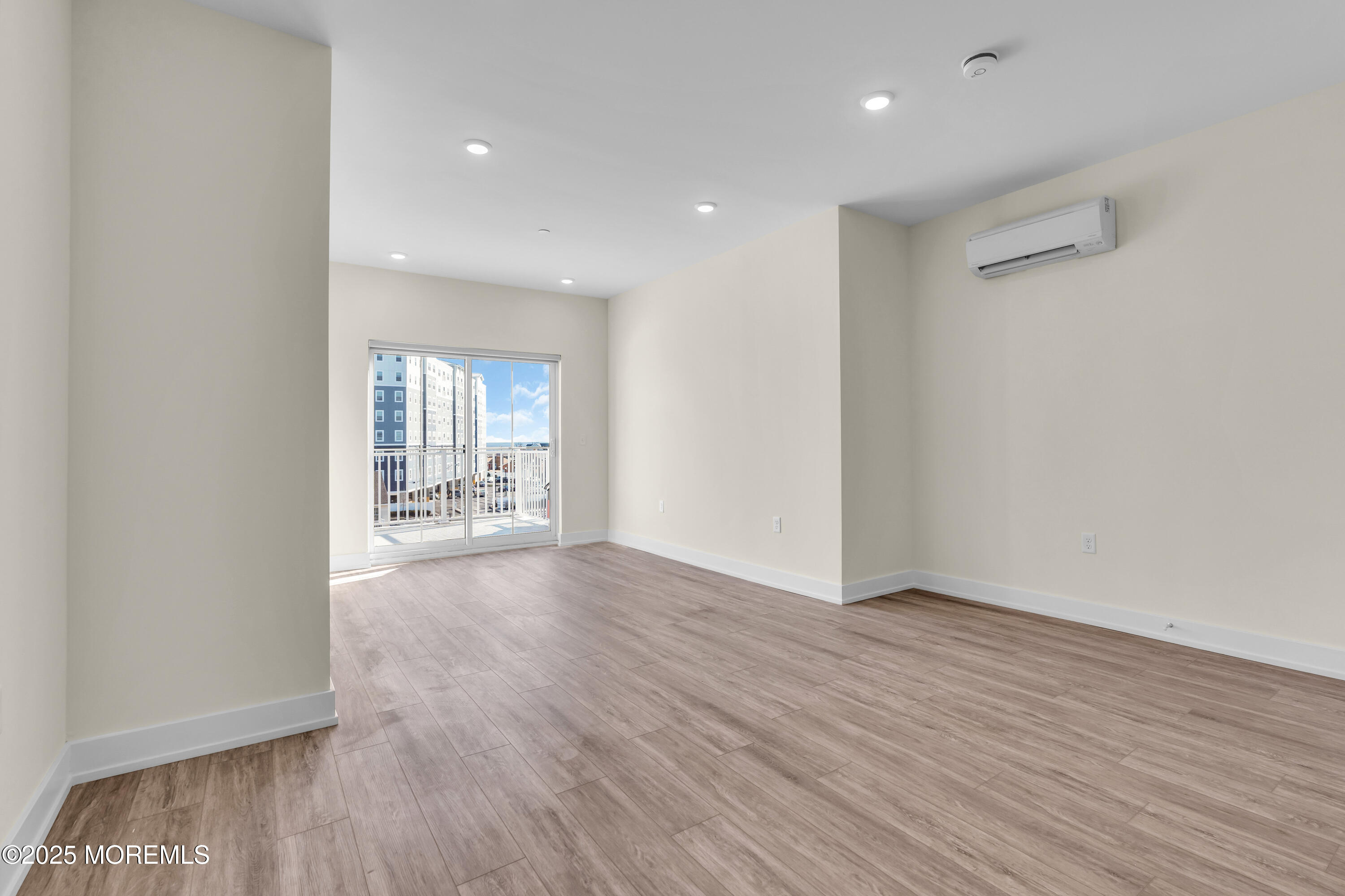 19 Carr Avenue, Unit 414 Keansburg, NJ 07734 - Photo 74 of 83 a view of an empty room with wooden floor and a window