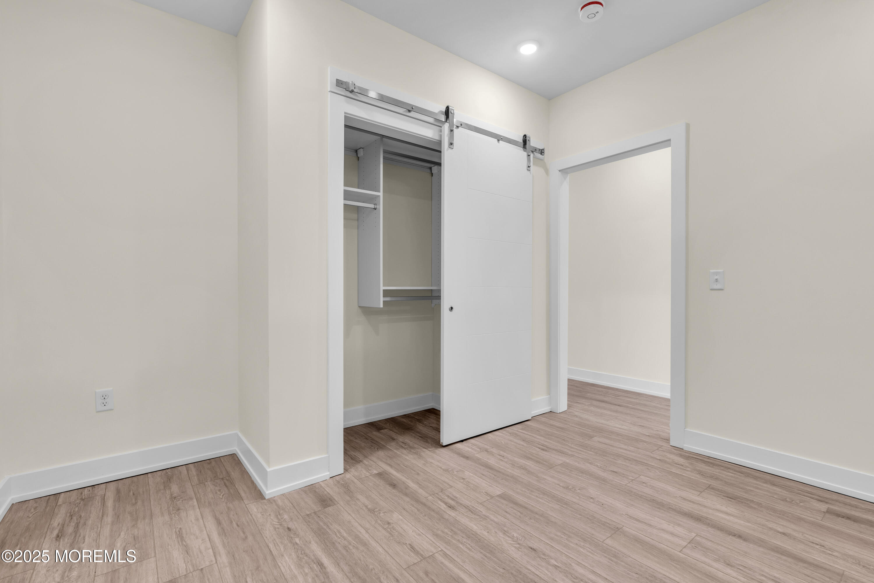 19 Carr Avenue, Unit 414 Keansburg, NJ 07734 - Photo 81 of 83 a view of an empty room with wooden floor and a window