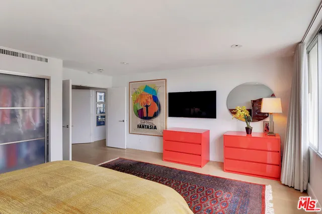 a bedroom with a bed and a television