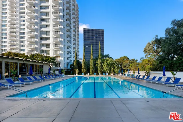 a view of a swimming pool with outdoor seating
