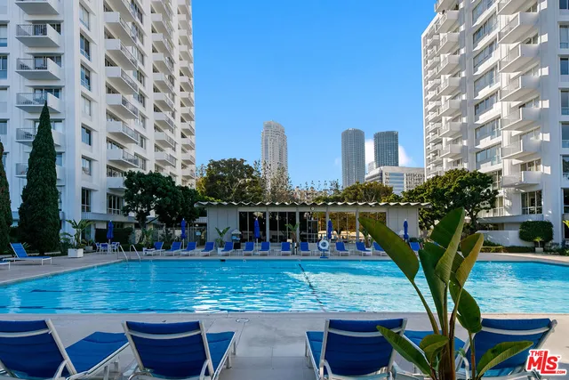 a view of swimming pool with outdoor seating