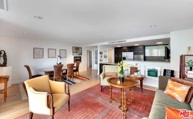 a living room with fireplace furniture and a wooden floor