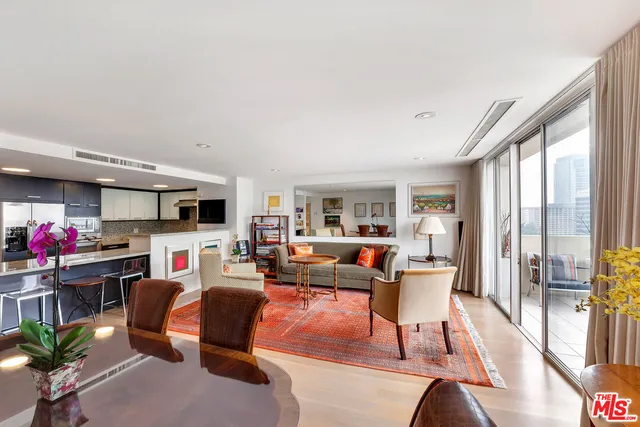 a living room with furniture a flat screen tv and a large window