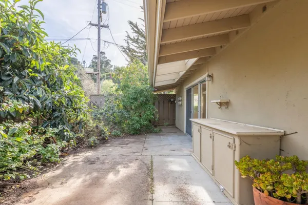 a view of a pathway of a house with a big yard